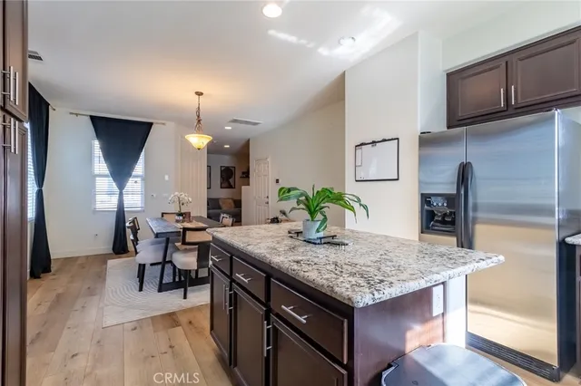 a kitchen with granite countertop kitchen island sink table and chairs