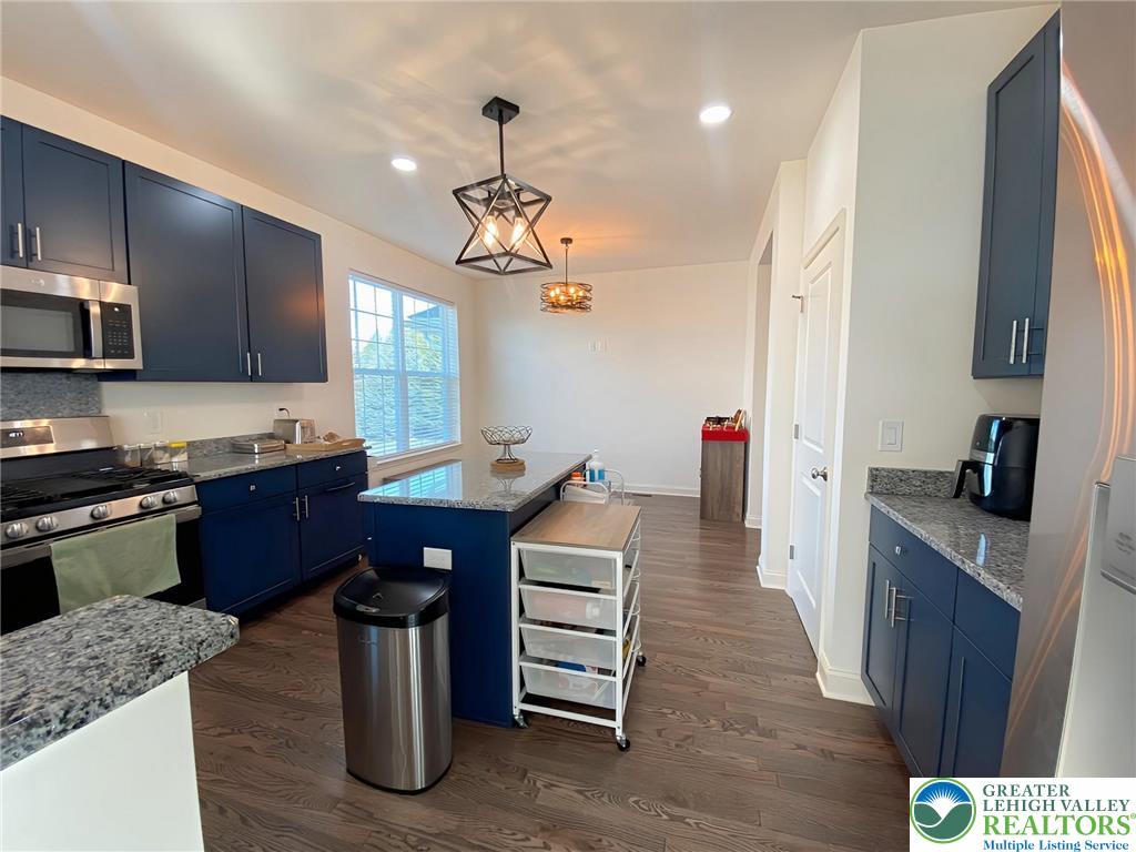 477 Newlins Road East Easton, PA 18040 - Photo 11 of 51 a kitchen with stainless steel appliances granite countertop a sink dishwasher a stove and a refrigerator with wooden floor