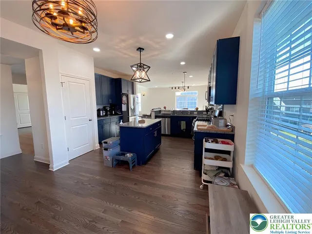 a view of kitchen with workspace and wooden floor