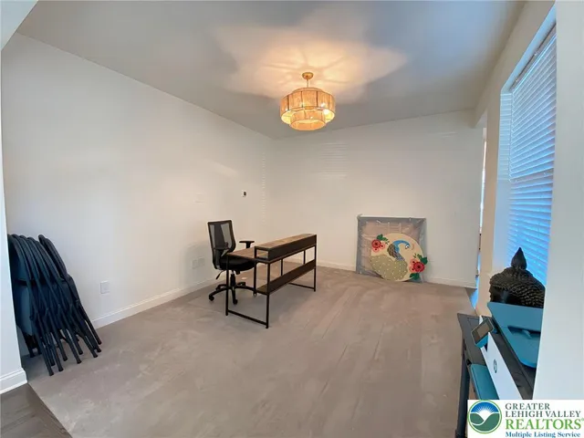 a view of a livingroom with furniture and a window