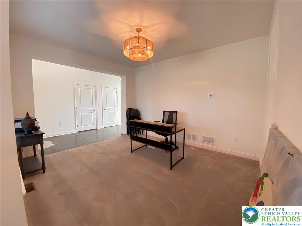 477 Newlins Road East Easton, PA 18040 - Photo 20 of 51 a living room with furniture and a chandelier