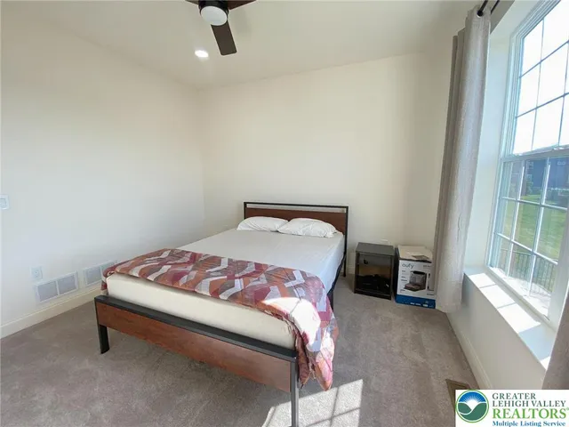 a bedroom with a bed and window