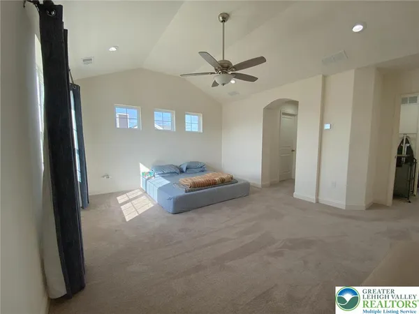 a living room with furniture and a ceiling fan