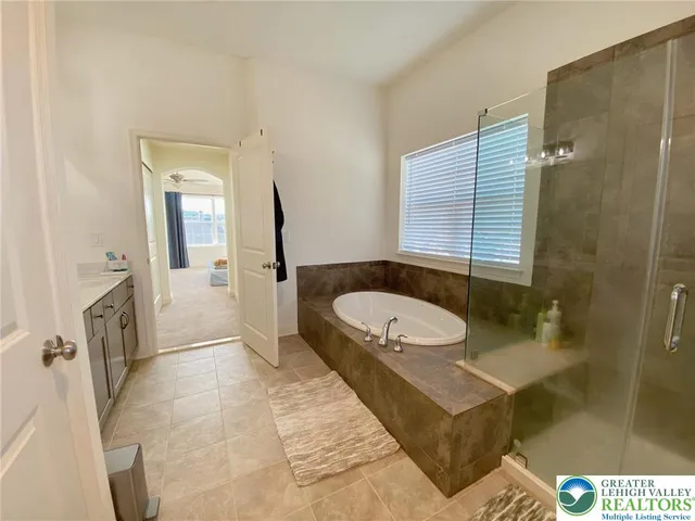 a bathroom with a tub a sink and a shower