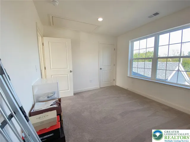 a view of an empty room and a window