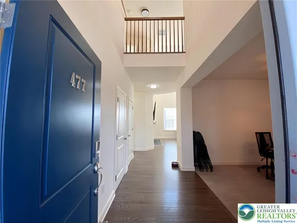 a view of hallway with stairs and wooden floor