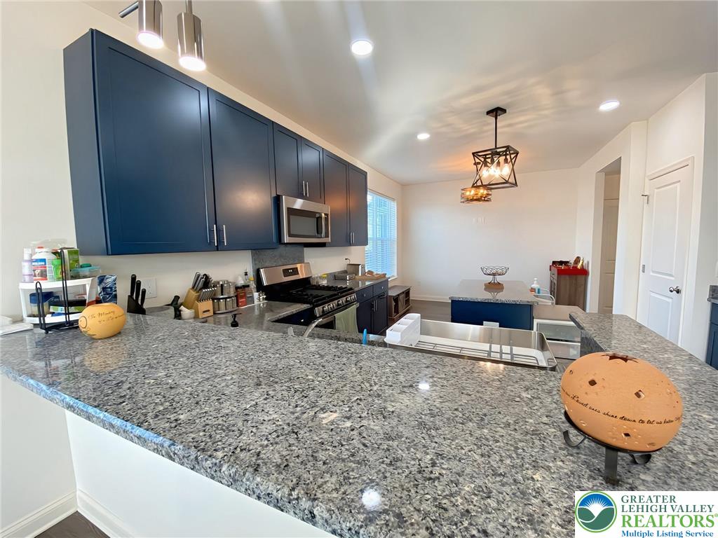477 Newlins Road East Easton, PA 18040 - Photo 8 of 51 a kitchen with sink a refrigerator and chairs