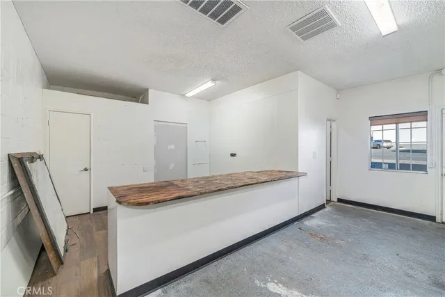 a view of a room with wooden floor
