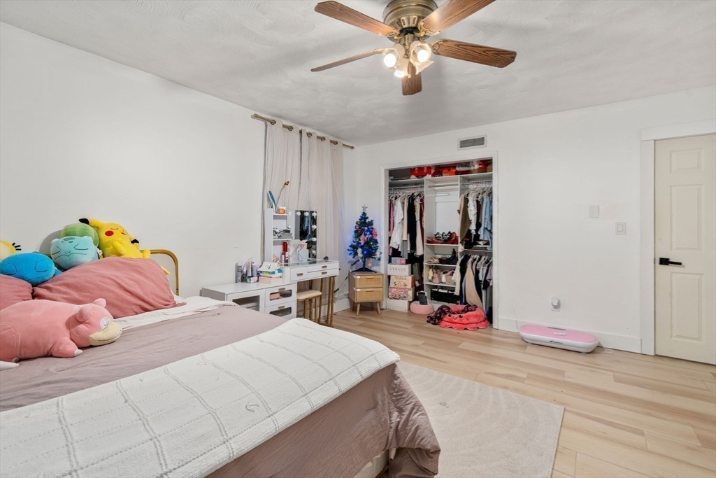 46 Ramshorn Road Dudley, MA 01571 - Photo 17 of 39 a bedroom with a bed and a chandelier