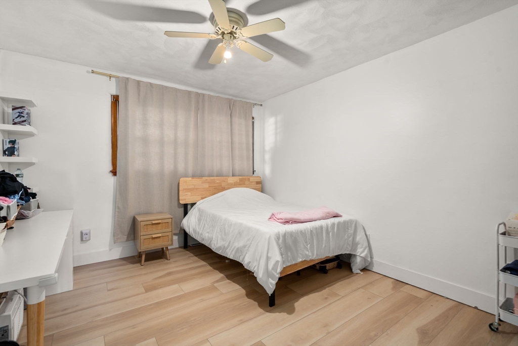 46 Ramshorn Road Dudley, MA 01571 - Photo 18 of 39 a bedroom with a bed and a chandelier