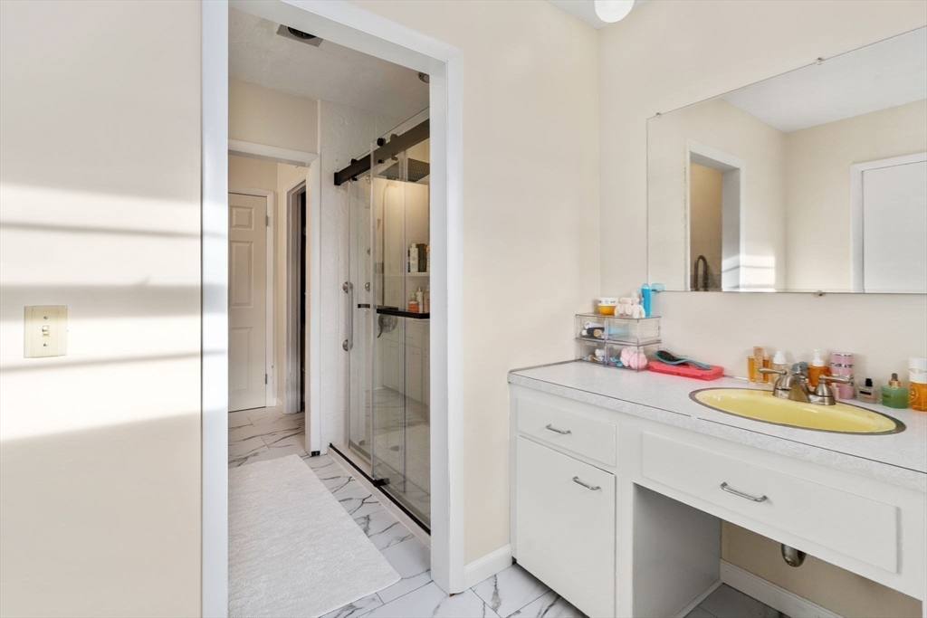 46 Ramshorn Road Dudley, MA 01571 - Photo 20 of 39 a bathroom with a double vanity sink mirror and shower