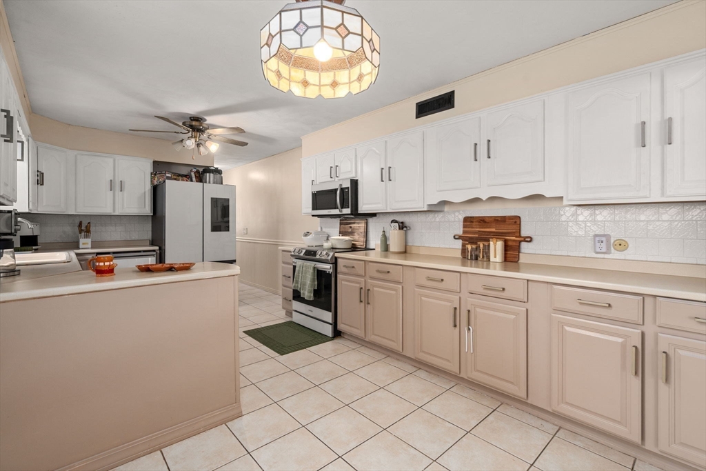 46 Ramshorn Road Dudley, MA 01571 - Photo 23 of 39 a kitchen with cabinets and chairs