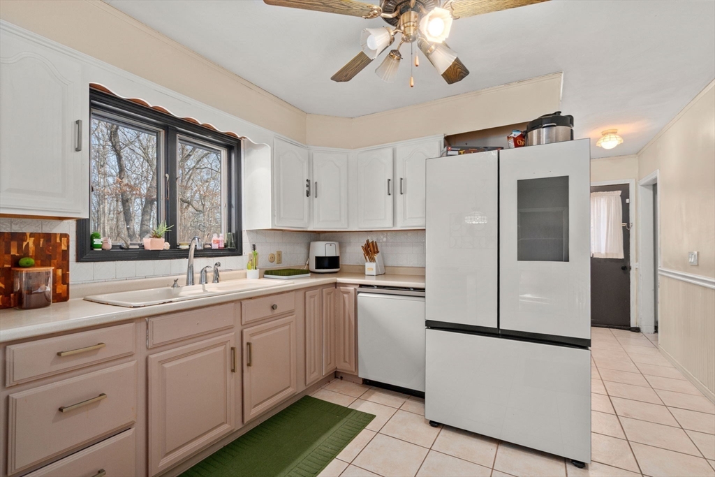 46 Ramshorn Road Dudley, MA 01571 - Photo 25 of 39 a kitchen with a refrigerator a sink and cabinets