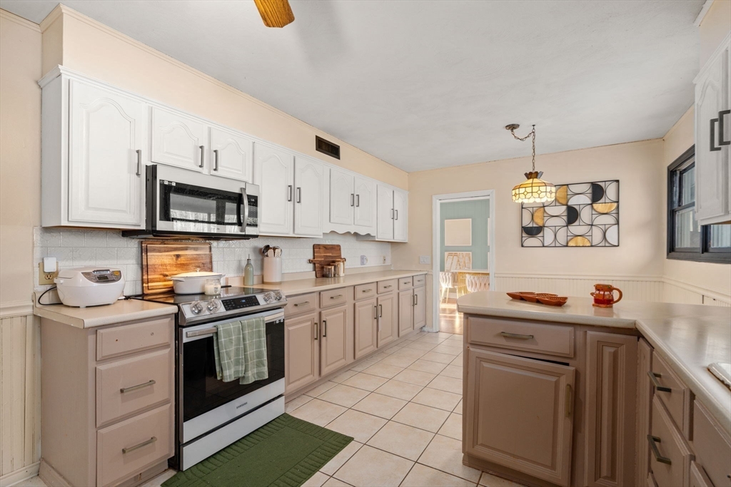 46 Ramshorn Road Dudley, MA 01571 - Photo 26 of 39 a kitchen with stainless steel appliances a stove microwave and sink