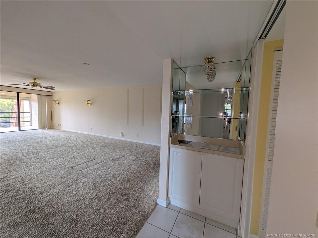 3100 Southeast Pruitt Road, Unit B301 Port St. Lucie, FL 34952 - Photo 19 of 40 View from hall to front bed and bath area