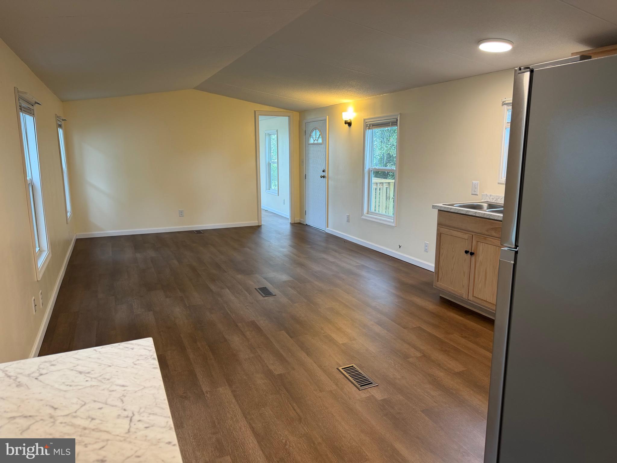 1104 West Elm Avenue Hanover, PA 17331 - Photo 7 of 13 a view of an empty room with wooden floor and a window