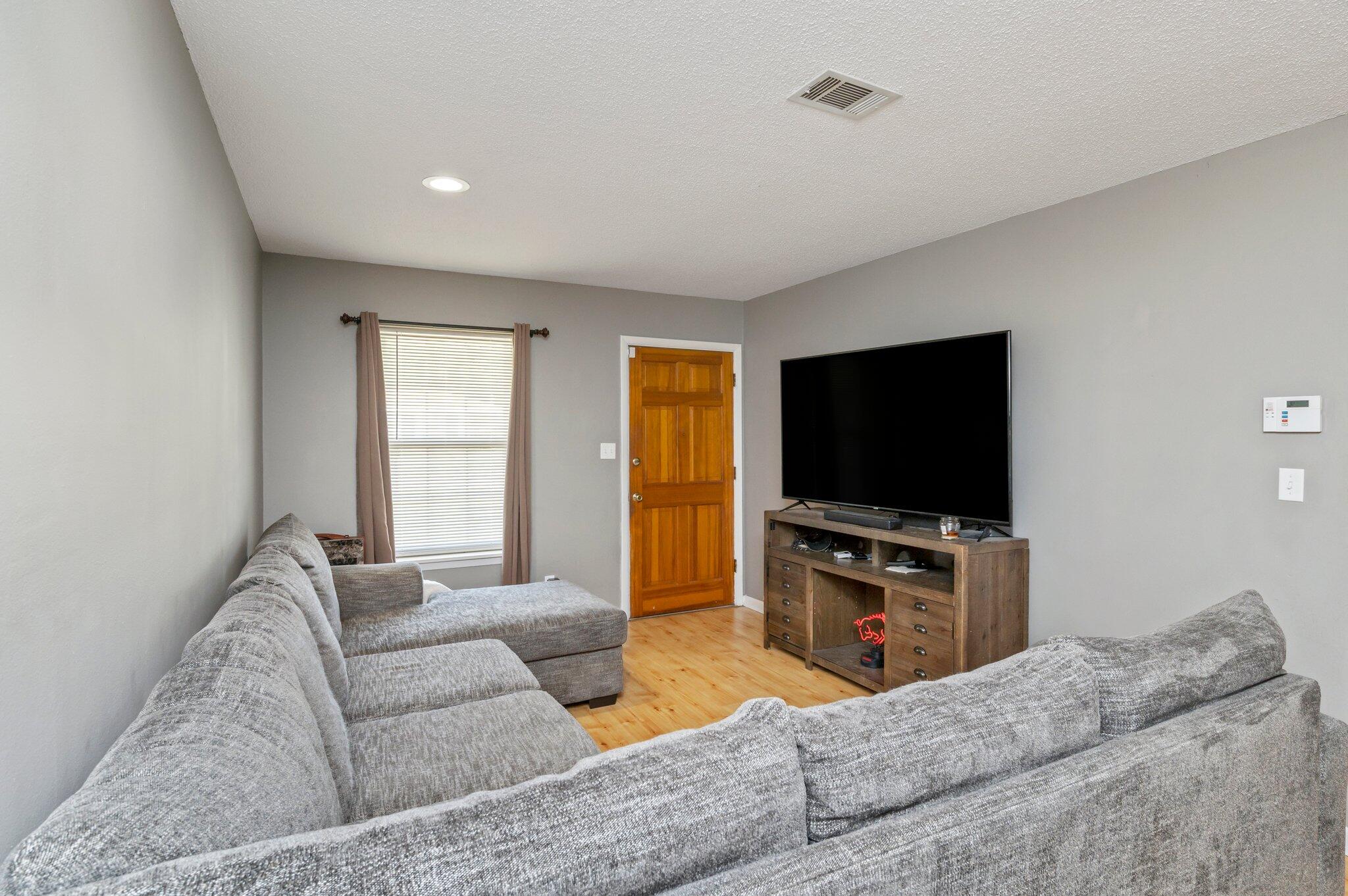 516 Stillwell Boulevard Crestview, FL 32539 - Photo 12 of 22 a living room with furniture and a flat screen tv