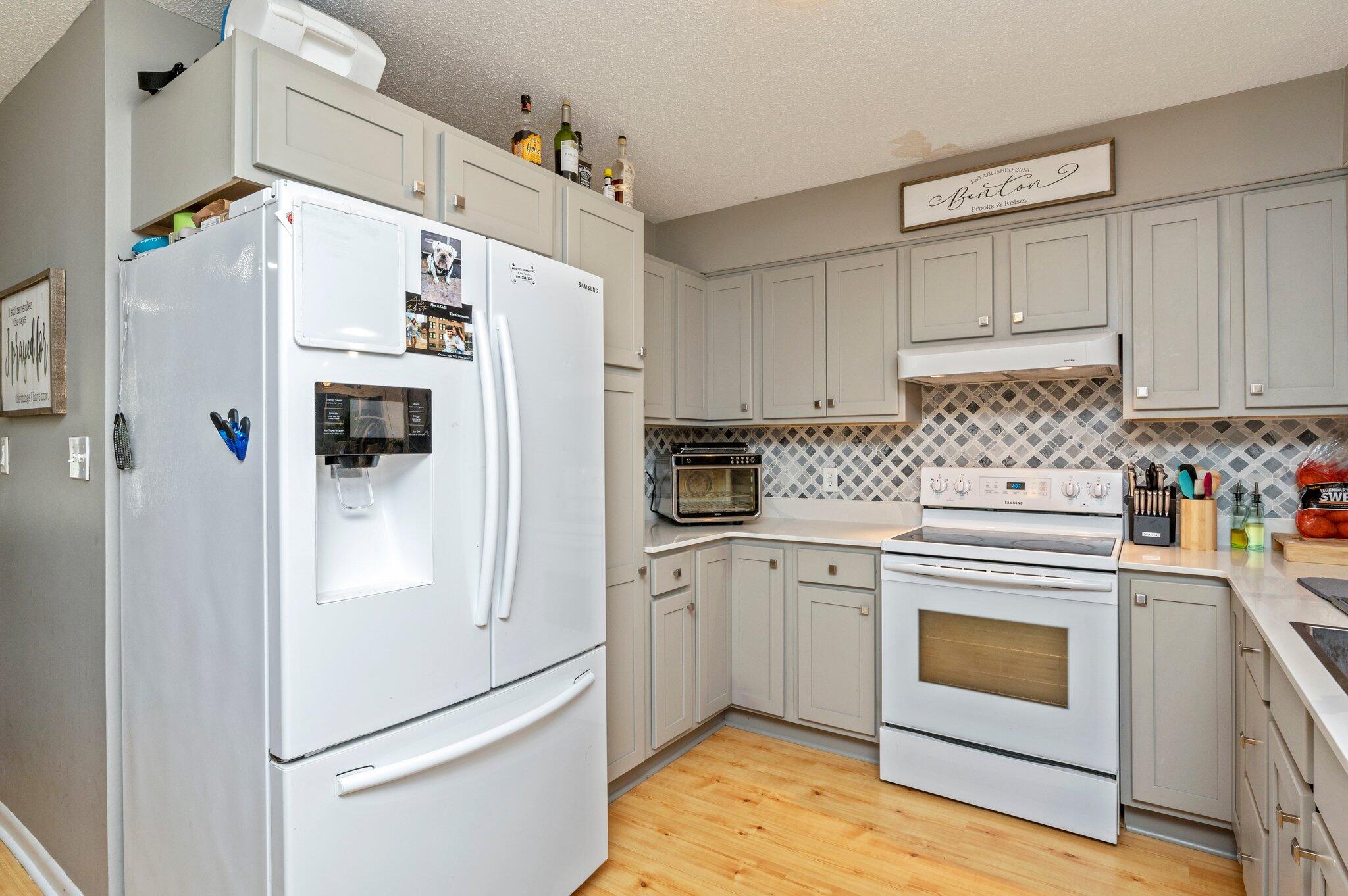 516 Stillwell Boulevard Crestview, FL 32539 - Photo 15 of 22 a kitchen with white cabinets and white appliances