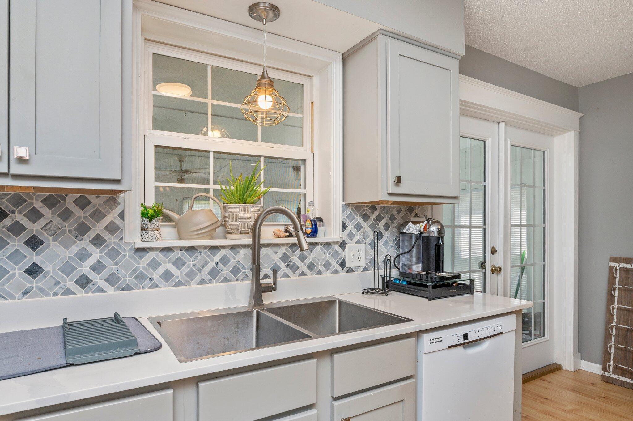 516 Stillwell Boulevard Crestview, FL 32539 - Photo 16 of 22 a kitchen with a sink and a stove top oven