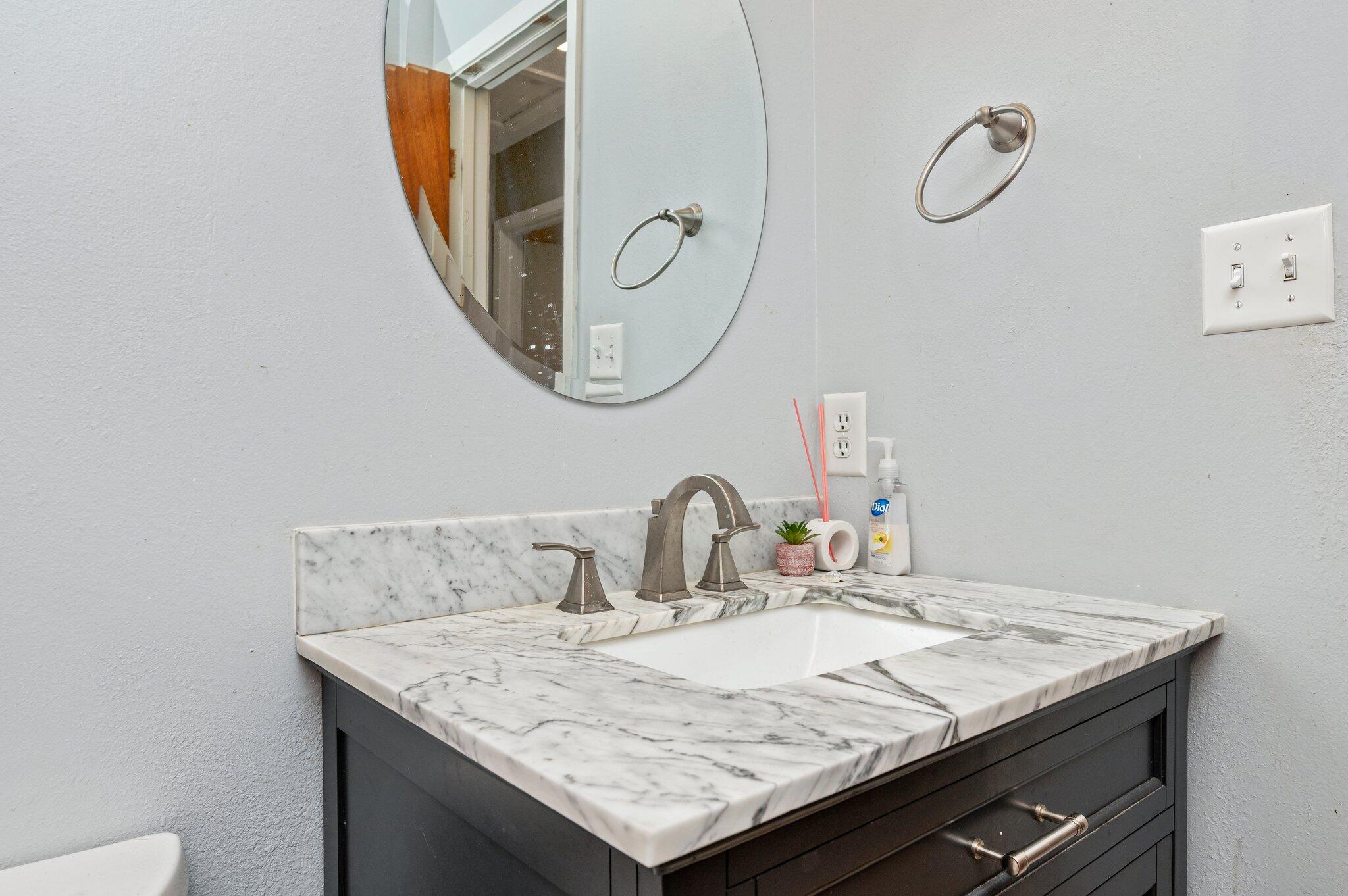 516 Stillwell Boulevard Crestview, FL 32539 - Photo 19 of 22 a bathroom with a granite countertop sink a mirror and a