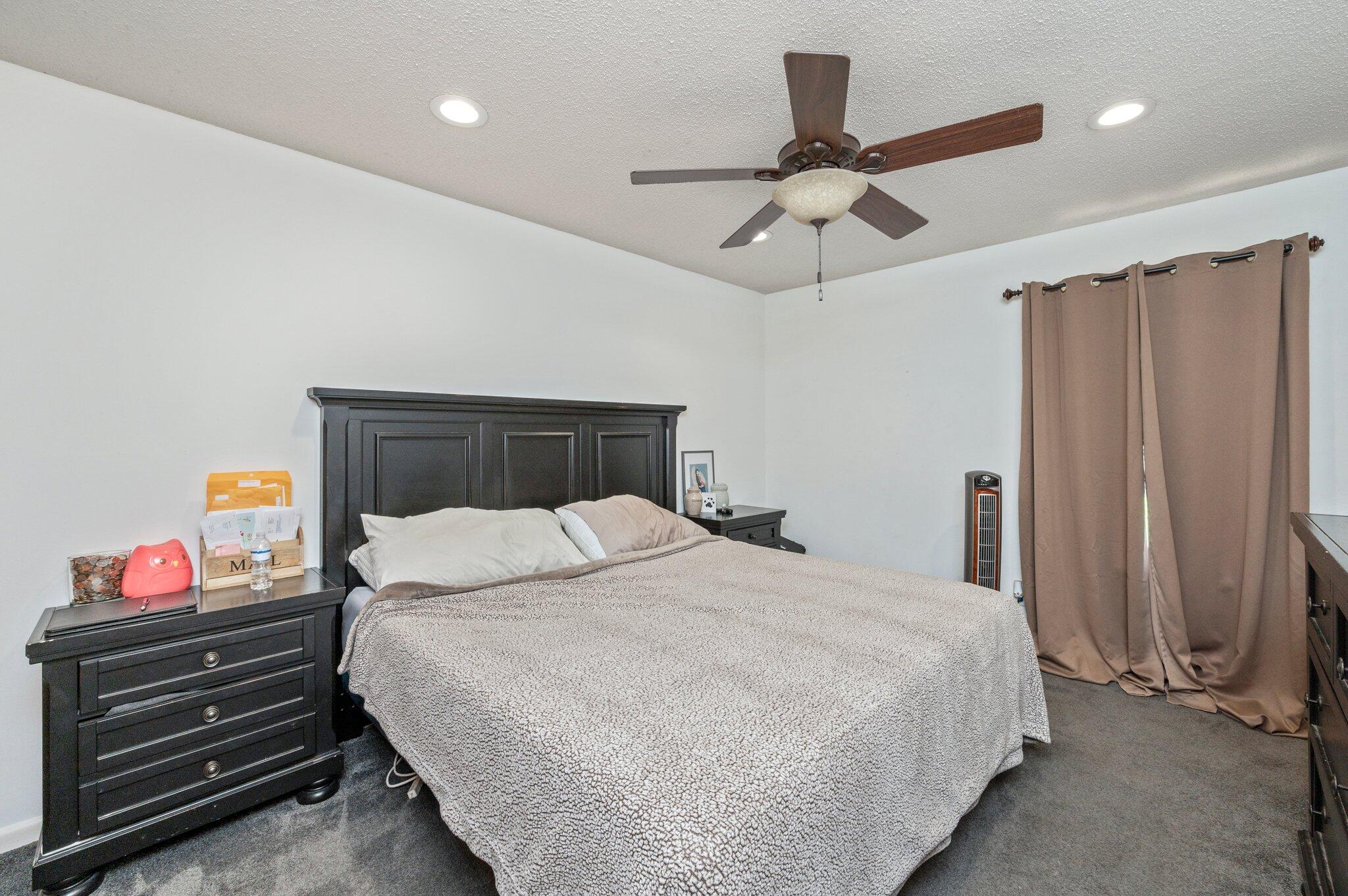 516 Stillwell Boulevard Crestview, FL 32539 - Photo 20 of 22 a bedroom with a bed and a chandelier