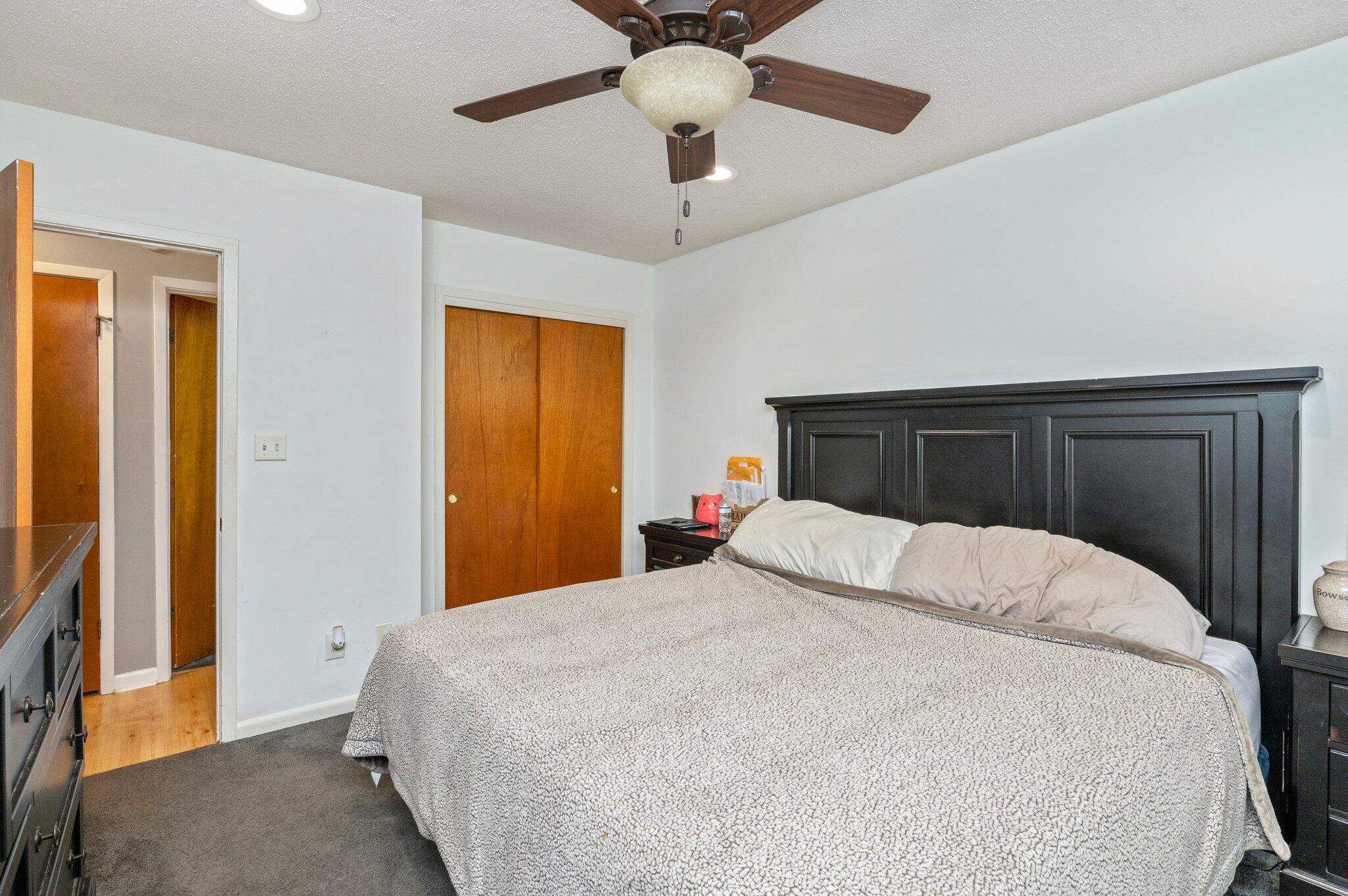 516 Stillwell Boulevard Crestview, FL 32539 - Photo 21 of 22 a bedroom with a large bed and a chandelier