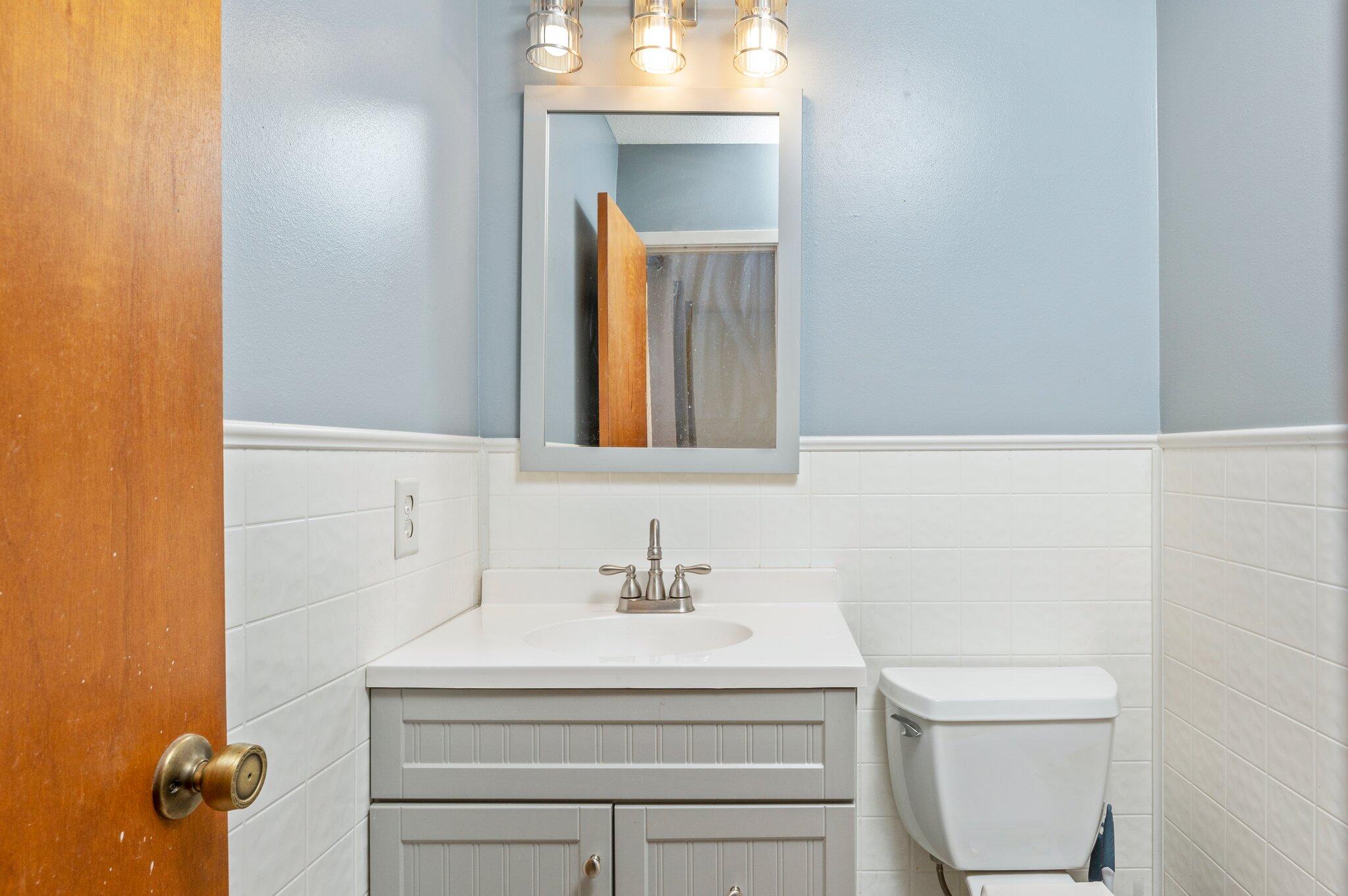 516 Stillwell Boulevard Crestview, FL 32539 - Photo 22 of 22 a bathroom with a sink a toilet and mirror