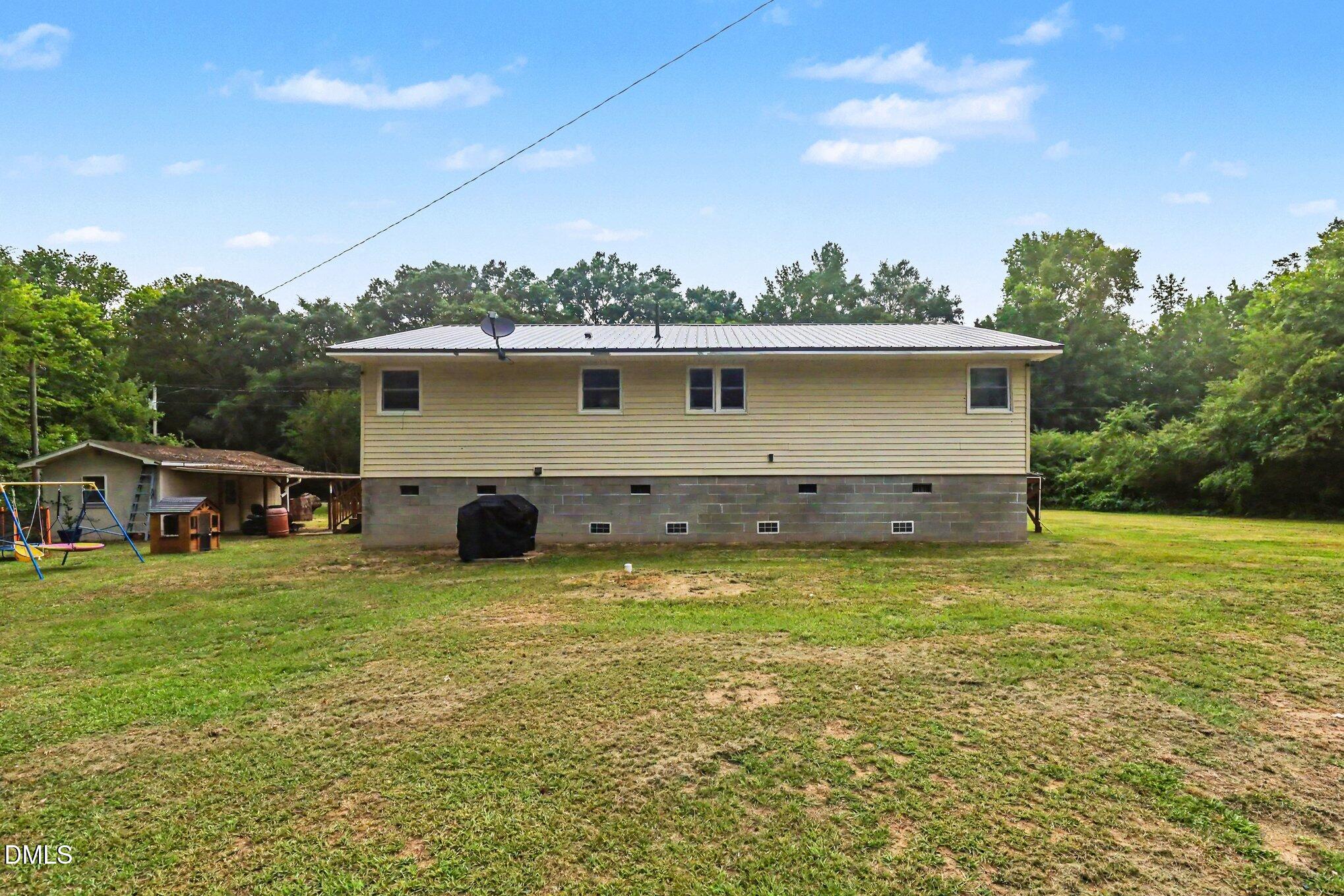 977 Stevens Mill Road Goldsboro, NC 27530 - Photo 28 of 31 a front view of house with yard and trees in the background