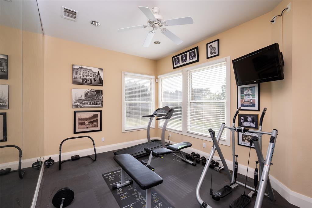 2312 Cactus Rio Lane Weatherford, TX 76087 - Photo 20 of 37 a living room with furniture gym equipment and a flat screen tv