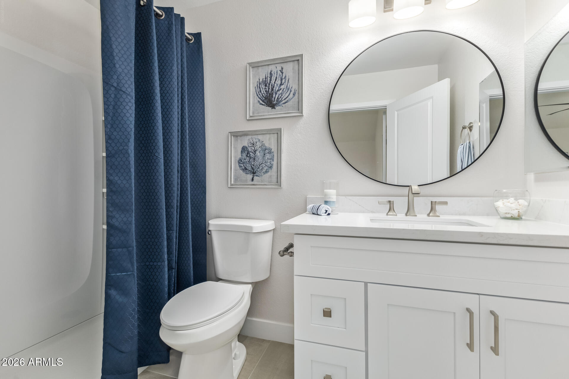 5808 East Brown Road, Unit 90 Mesa, AZ 85205 - Photo 17 of 29 a bathroom with a toilet sink and mirror