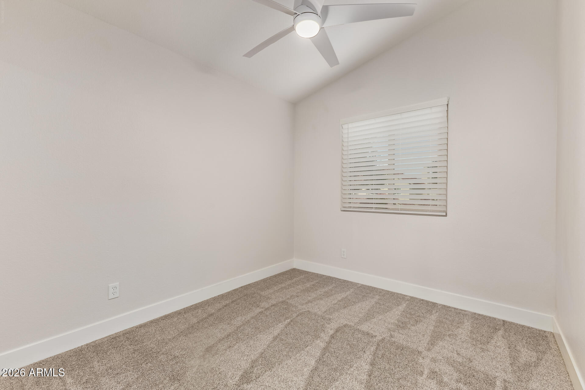 5808 East Brown Road, Unit 90 Mesa, AZ 85205 - Photo 19 of 29 an empty room with a ceiling fan and a window