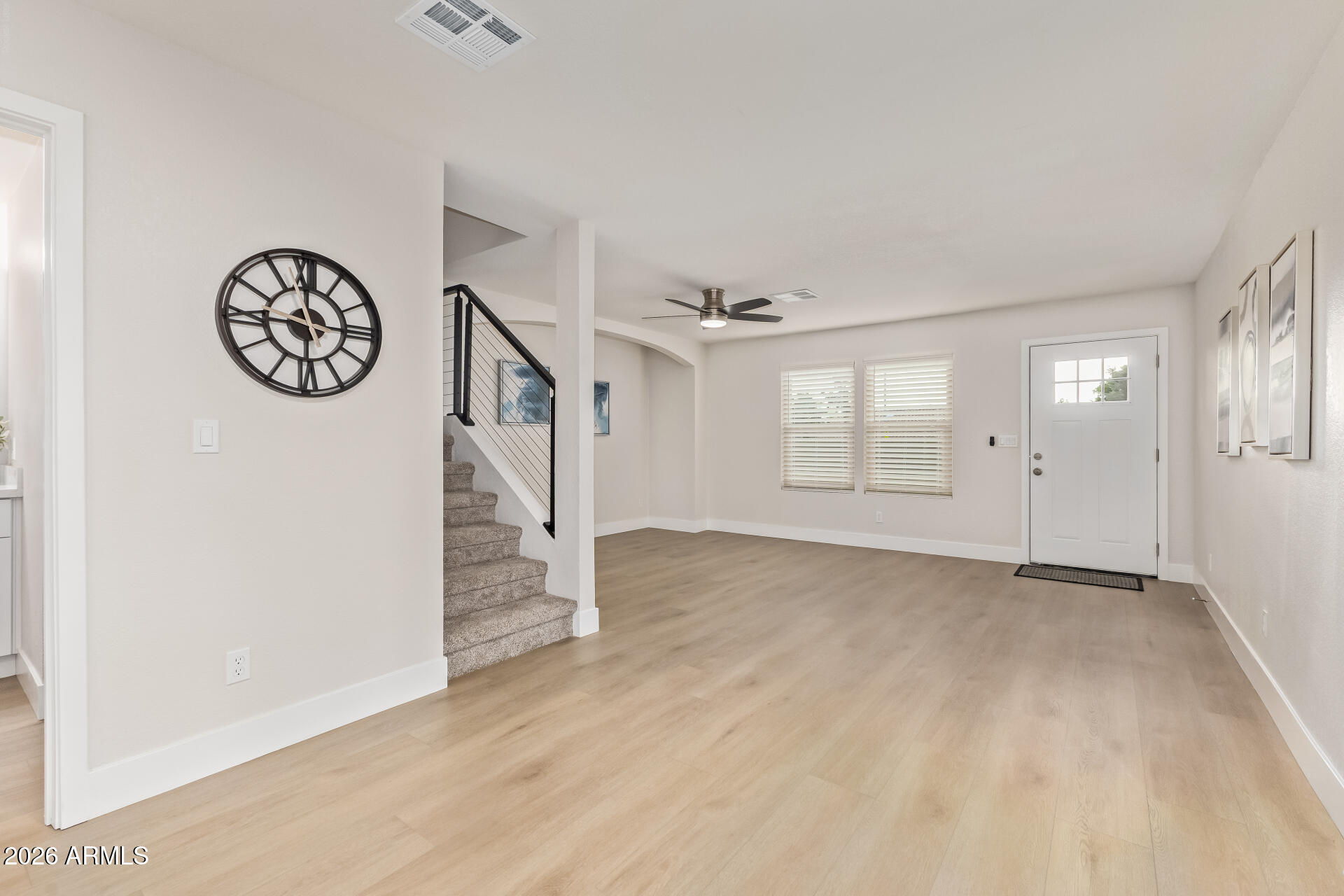 5808 East Brown Road, Unit 90 Mesa, AZ 85205 - Photo 3 of 29 a view of an empty room with wooden floor and window