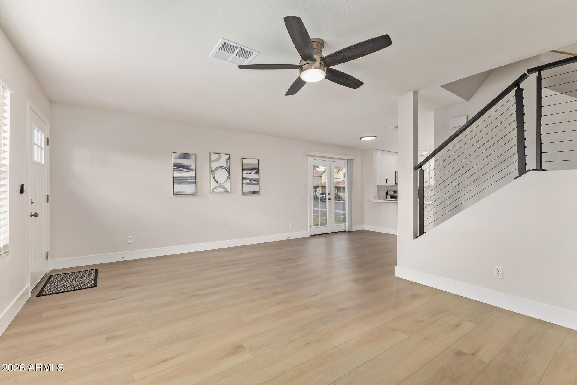 5808 East Brown Road, Unit 90 Mesa, AZ 85205 - Photo 5 of 29 wooden floor in an empty room with a window