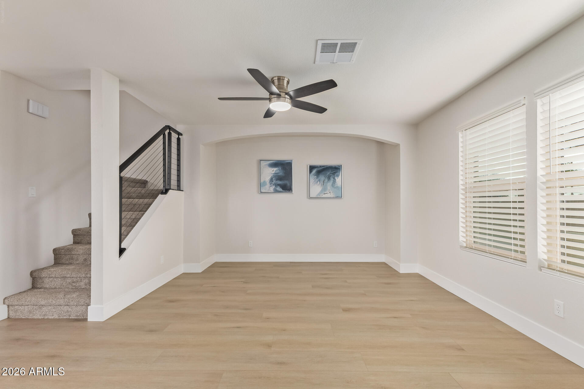 5808 East Brown Road, Unit 90 Mesa, AZ 85205 - Photo 6 of 29 a view of a livingroom with wooden floor and a ceiling fan