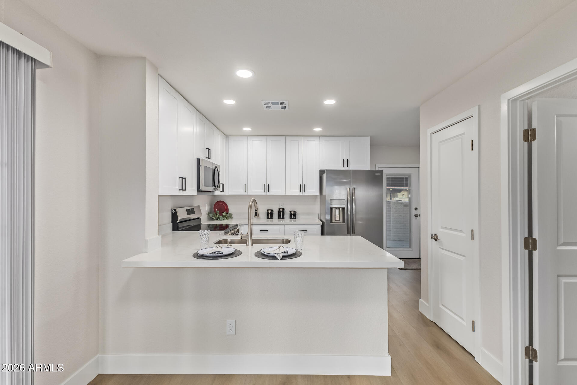 5808 East Brown Road, Unit 90 Mesa, AZ 85205 - Photo 8 of 29 a kitchen with stainless steel appliances granite countertop a sink a refrigerator and a refrigerator