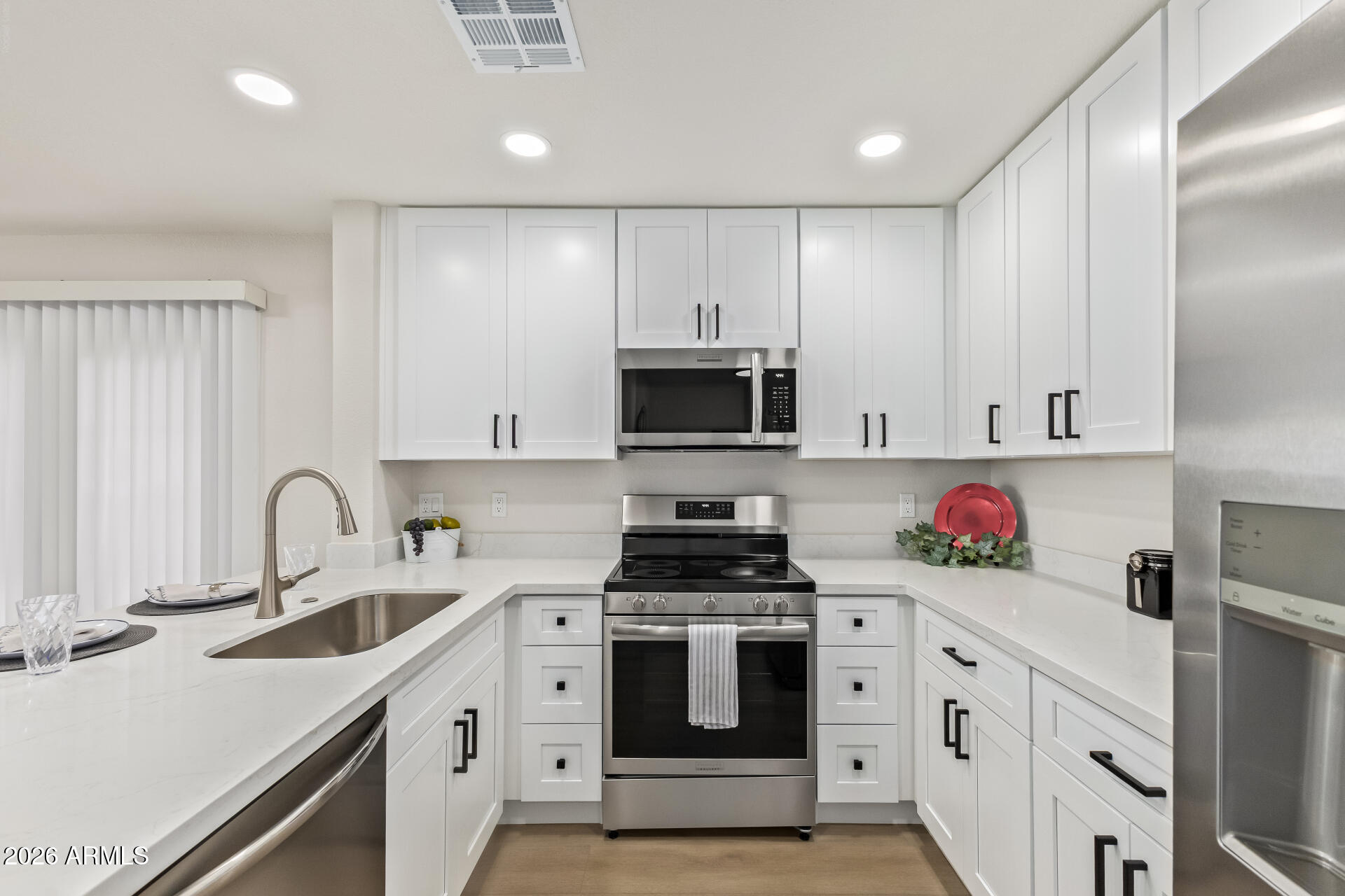 5808 East Brown Road, Unit 90 Mesa, AZ 85205 - Photo 9 of 29 a kitchen with granite countertop a sink stainless steel appliances and cabinets