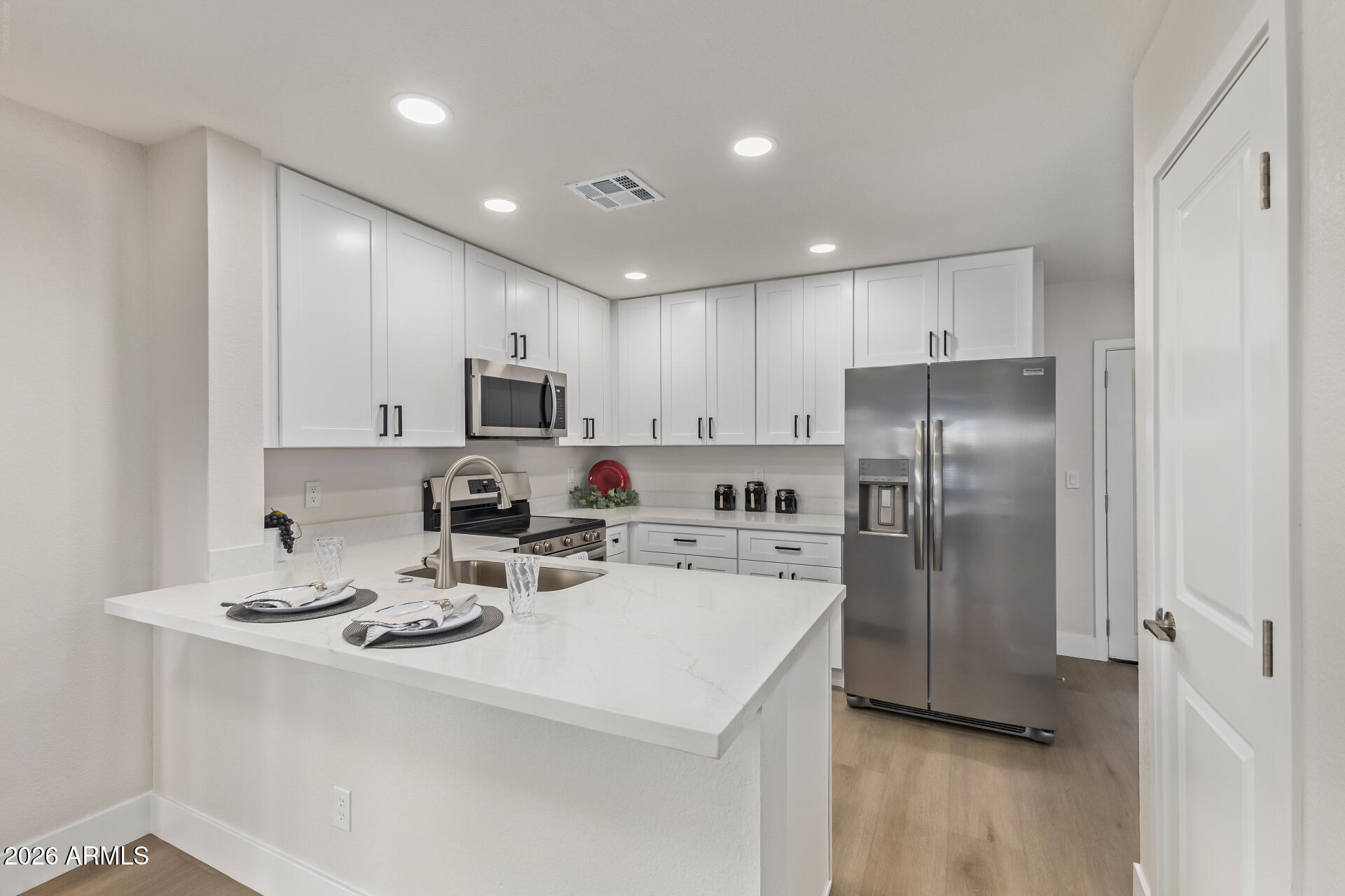 5808 East Brown Road, Unit 90 Mesa, AZ 85205 - Photo 10 of 29 a kitchen with stainless steel appliances a refrigerator sink and microwave