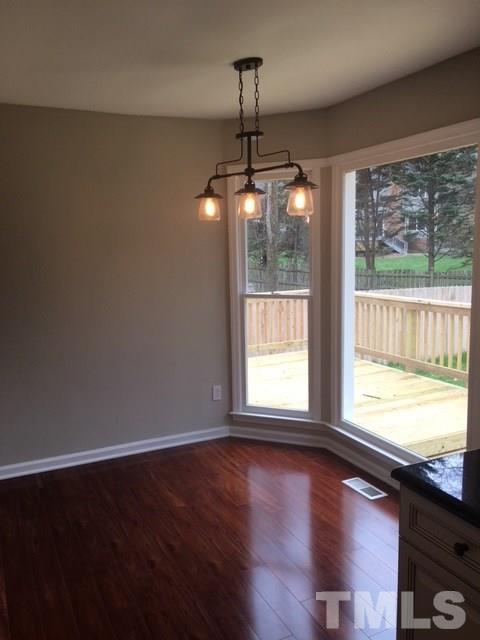 8105 Greywinds Drive Raleigh, NC 27615 - Photo 5 of 18 a view of an empty room with wooden floor and a window