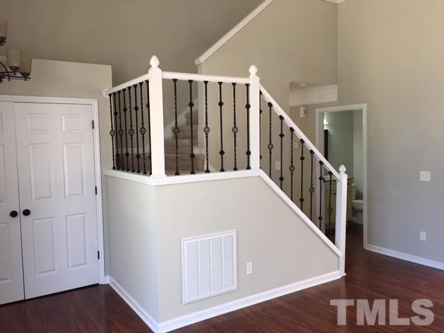 8105 Greywinds Drive Raleigh, NC 27615 - Photo 9 of 18 a view of a hallway with entryway wooden floor and windows