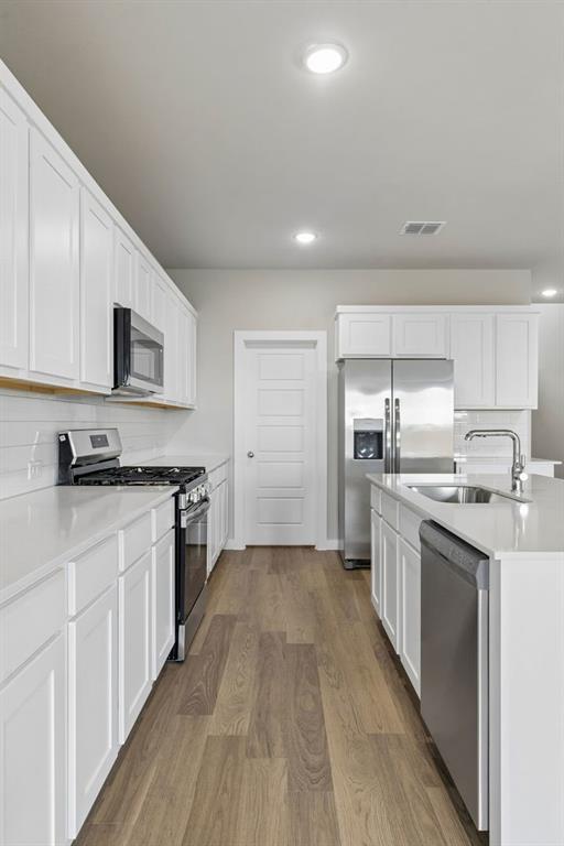 1121 Del Rio Drive Lavon, TX 75166 - Photo 7 of 32 a kitchen with stainless steel appliances granite countertop a sink and cabinets