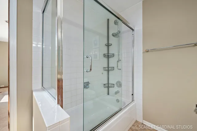 a bathroom with a bathtub and a shower