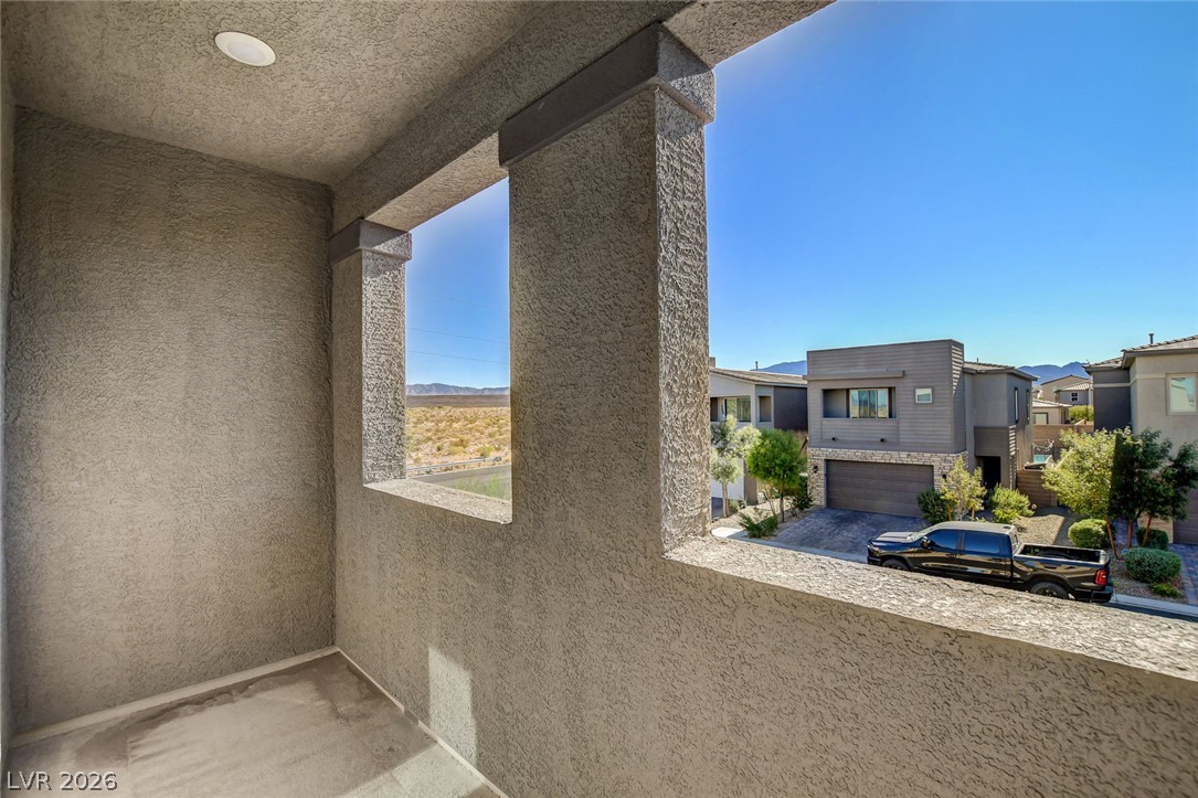 9688 Rankin Rdg Court Las Vegas, NV 89178 - Photo 41 of 53 Framed views from this balcony reveal desert landscapes and distant mountains, complementing modern architecture.