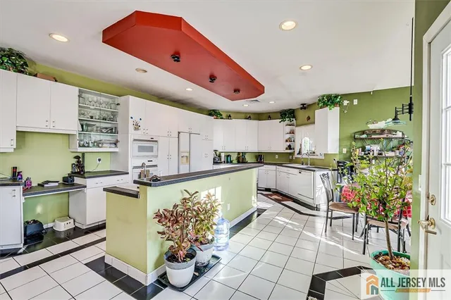 a kitchen with stainless steel appliances granite countertop a refrigerator and a stove