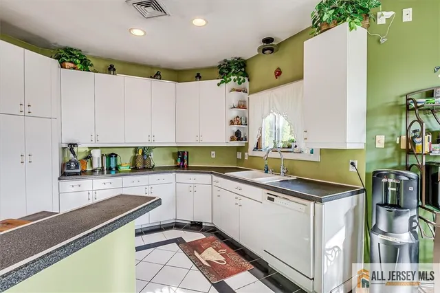 a large kitchen with stainless steel appliances granite countertop a stove and a sink