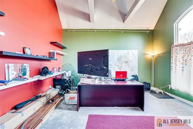 a hallway with a bed and a chair