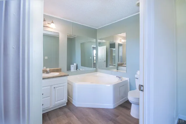 a spacious bathroom with a double vanity sink mirror and bathtub