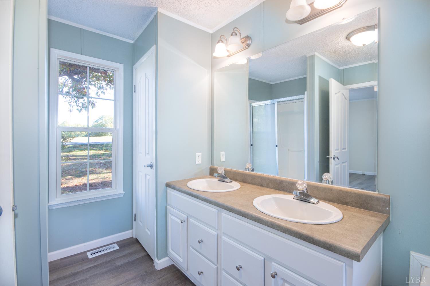 4791 Salem Road Spout Spring, VA 24593 - Photo 14 of 17 a bathroom with a granite countertop sink and a mirror