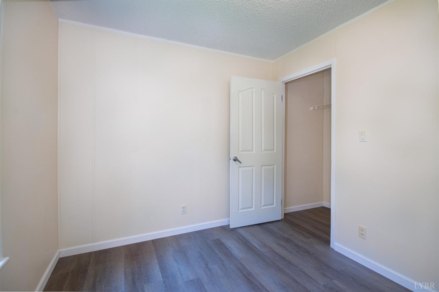 4791 Salem Road Spout Spring, VA 24593 - Photo 8 of 17 a view of an empty room with wooden floor