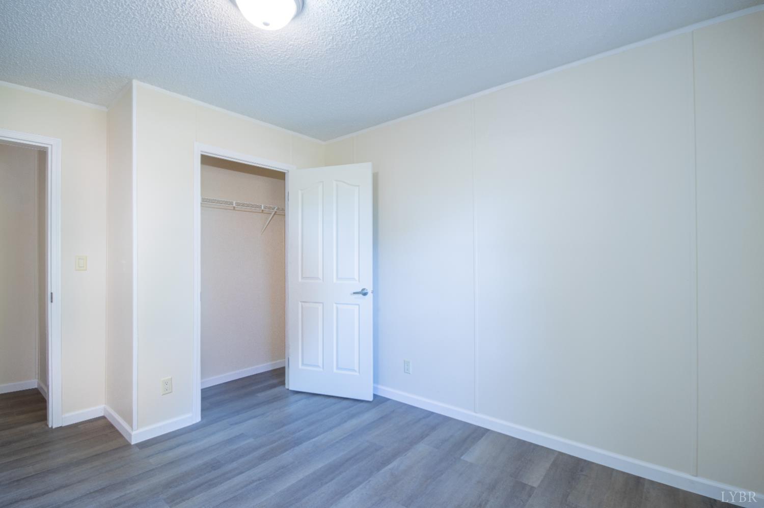 4791 Salem Road Spout Spring, VA 24593 - Photo 10 of 17 a view of an empty room with wooden floor