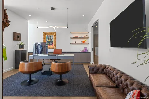 a living room with furniture a rug and a flat screen tv